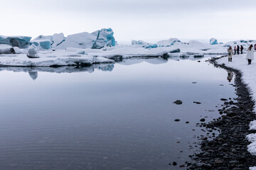 Fototapeta na wymiar Panorama on Winter Jokulsarlon Glacier is an icy beach where ice floes float