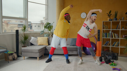 Slim and chubby funny fitness guys doing warm-up stretching exercises together at home. Sports freaks. Concept of friendship, team, humor.