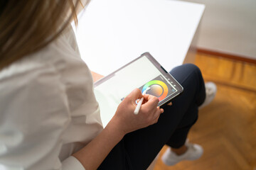 Business woman hands close up working with tablet in modern office wearing white shirt black pants