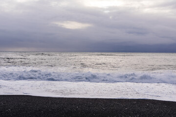 Reynisfjara black beach and the waves of the winter Atlantic Ocean