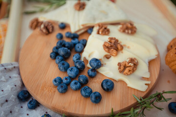 picnic time: cheese and blueberries on a round board