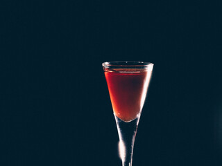 Shot glass containing red drink