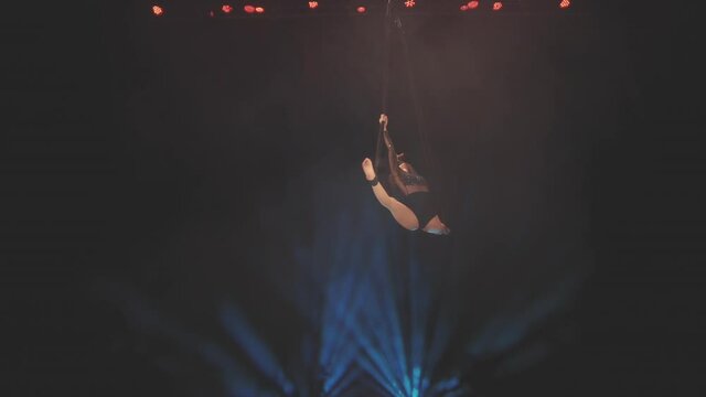 Young girl doing aerial acrobatic elements