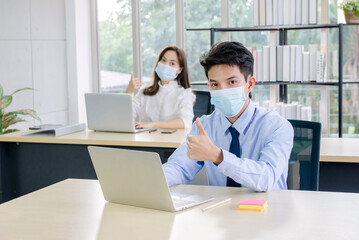 business couples with facemask in office