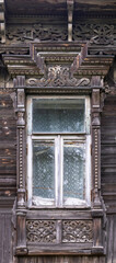 Fototapeta na wymiar Old wood carving jamb trim window frame. Russian traditional architectural detail