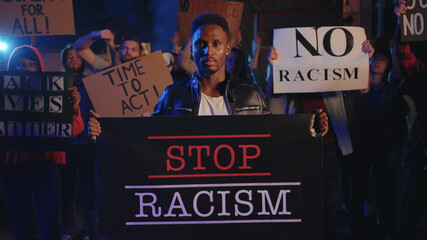 Stop Racism. Strong severe african american protester taking part in street riot against police...