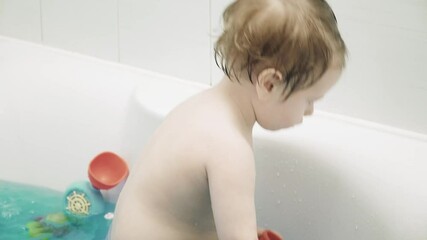 Boy child bathes in bath