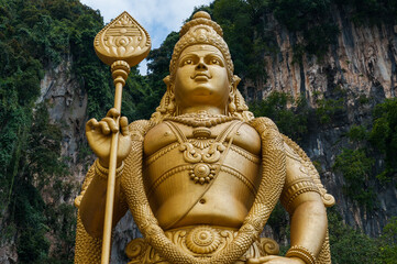 Large Statue of Murugan (Karttikeja) in Batu Caves, Kuala Lumpur, Malaysia. Upper part with gold...