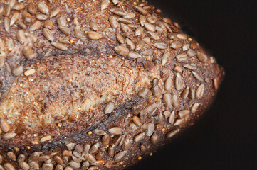 Artisan Loaf of bread on Black Background with Sunflower Seeds