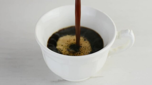 Freshly brewed hot coffee served in a white coffee cup