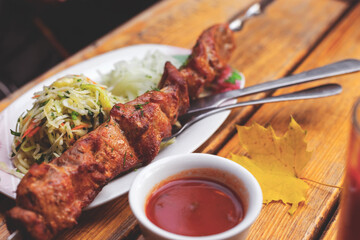 Grilled pork shashlik with pickled onions. Autumn still life in a rustic style.  Selective focus. Tinted background