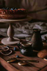 Still life of apple pie, berries, coffee and lemons on wooden tray