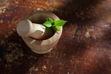 close up view of wooden herbal mortar on color  back