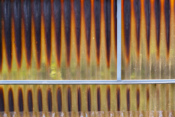 Old and stained acrylic corrugated sheets in a abandoned greenhouse