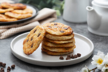 Stack of chocolate chip cookies. Dark background. Sweet delicious snack.