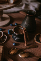 Naklejka premium Still life of apple pie, berries, coffee and lemons on wooden tray