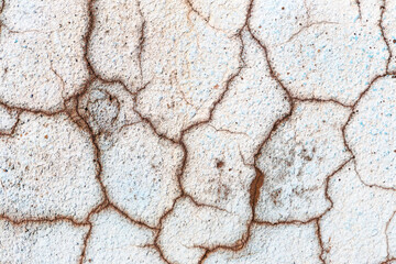 Fototapeta premium Great colorful background or texture. Abstract concrete is aged with cracks, scratches and remnants of old paint in different shades. Rough concrete surface