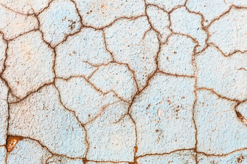 Abstract creative background of chaotic strokes of old cracked paint on concrete wall. Old surface with traces of paint, weathered, scratches and cracks for design