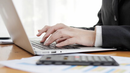 close up of a businesswoman typing on a laptop Hands operating a computer keyboard, AI generated
