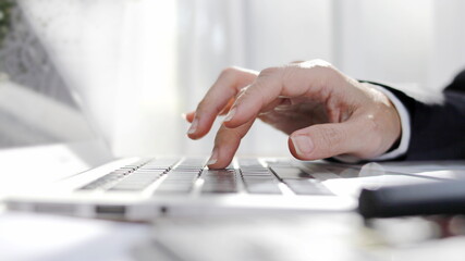 Hands operating a computer keyboard, AI generated businessman typing on a laptop