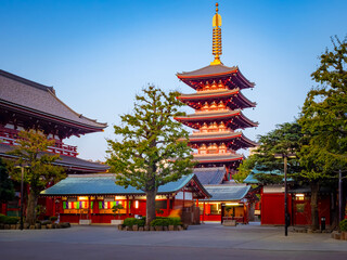 Japan. Tokyo. Sights of the Japanese capital. Asakusa temple in Tokyo. Red Buddhist temple against a blue sky. Japanese architecture. Travel to Japan. Tokyo's iconic buildings.