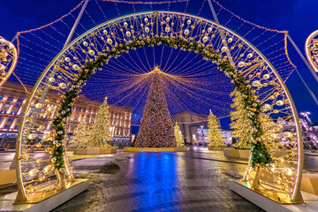 Moscow. Russia. Decoration of the Moscow Manege square for Christmas. Festive evening in the capital of Russia. Christmas trees, garlands and shiny balls on Manezh square. New year in Russia.