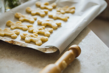 Making of gingerbread man on the kitchen. Selective focus.
