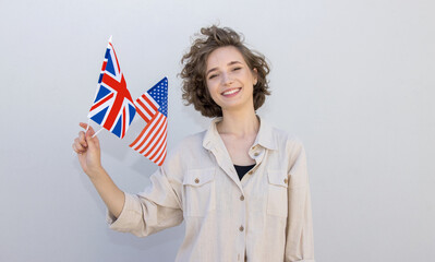 Smiling woman with flags USA and United Kingdom, countries of English language speaking. Study abroad.