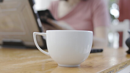 coffee cup placed on a business man's desk at the office.