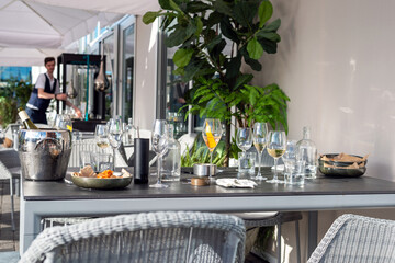 Empty table at the restaurant after the dinner. Empty wine and water glasses and dirty tableware. 