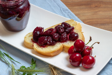 homemade cherry jam on the table with fresh cherries