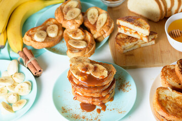 French toast with banana and homemade caramel with cinnamon, Breakfast dessert on a blue plate on a light background