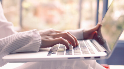 woman  hand  using a laptop computer  concept of using technology to send emails