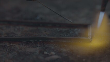 Jeweler makes jewelry of silver. The jeweler to melt silver, makes patterns on it, grinds, cuts and drills. work gas torch