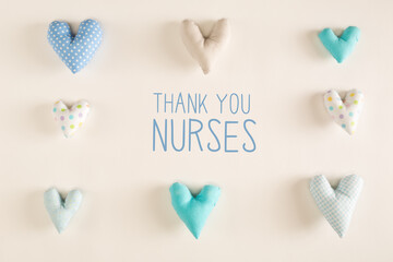 Thank You Nurses message with blue heart cushions on a white paper background