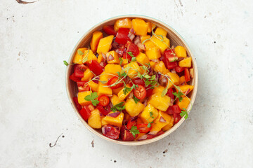 Fresh salad with mango, red pepper, tomatoes and cilantro.