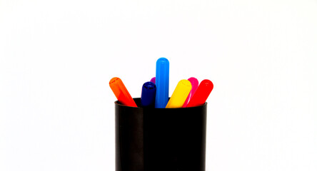 Colored pencils in a glass isolated on a white background