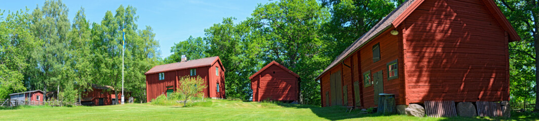 Old wooden farmhouses painted in traditional Falun-red, Sweden