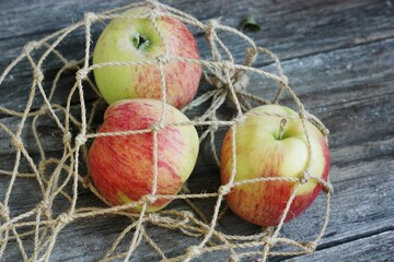 Ripe green apples in a string bag