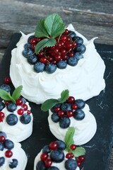Anna Pavlova dessert with blueberries and red currants