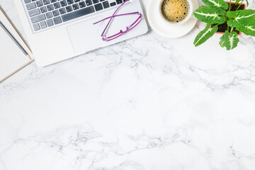 Laptop and blank notebook with hot coffee on marble table background