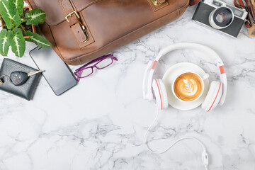 Coffee with headphone and vintage Leather bag, smartphone and vintage camera
