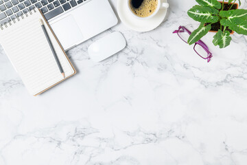 Pencil on blank notebook with laptop and black coffee on marble table background,