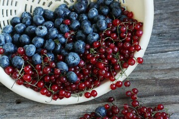 Fresh blueberries and red currants on the table