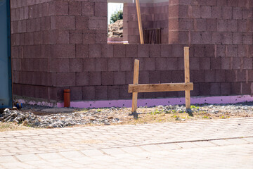 Building site of a house under construction. Unfinished house wall made from concrete blocks