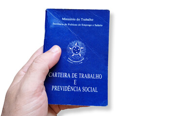 Man's hand holding Brazilian Work Card isolated on white background. Written in Portuguese Federative Republic of Brazil, Ministry of Labor. Work and Social Security card. Brazilian work concept.