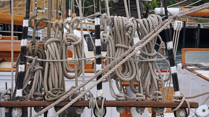 Lines, ropes, halyards, knots in the rigging of a two masted brigantine sailing boat replica