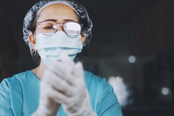 Senior doctor prepare herself before go to surgery room.