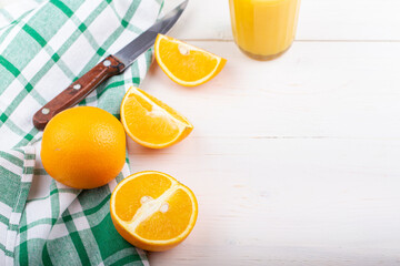 Sliced orange on a white wooden background.