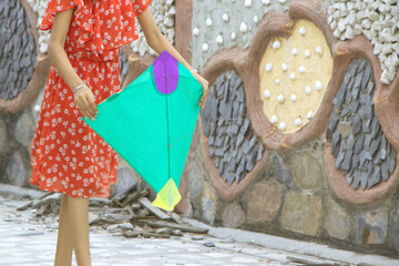 Girl with a kite thread rollerin her hand